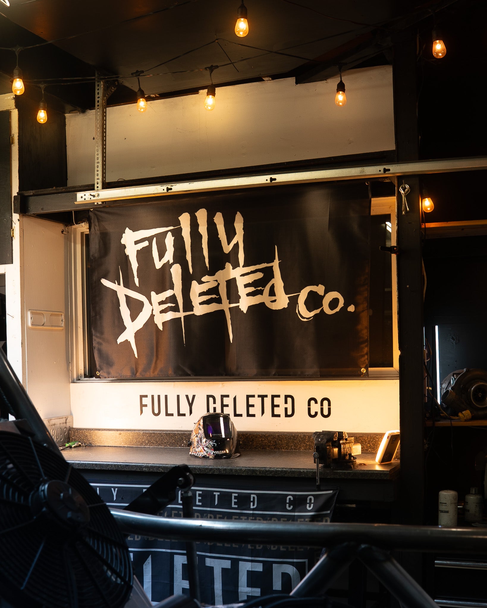 Truck with 'Fully Deleted Co.' branding in a dark setting