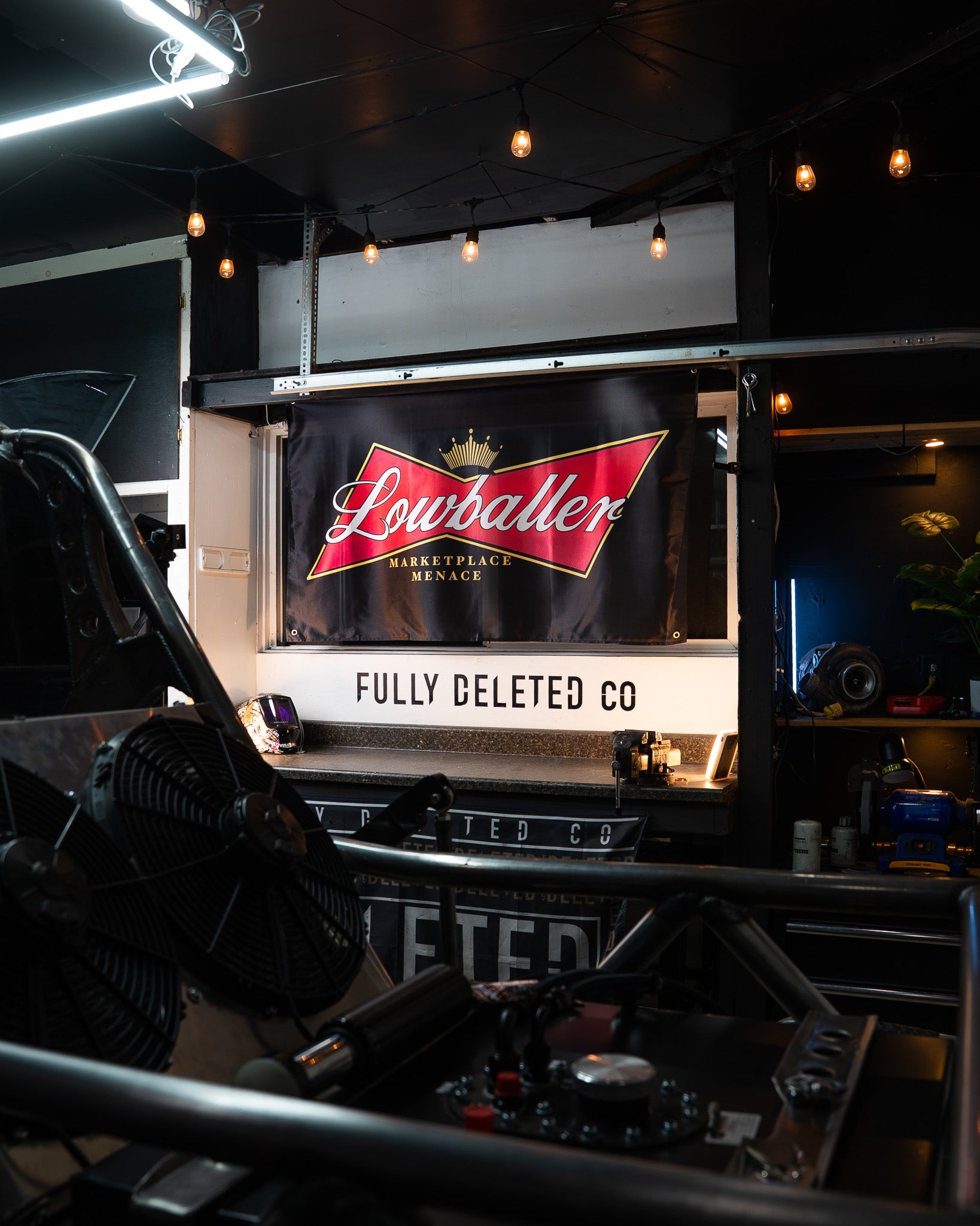 Truck interior with 'Lowballer' and 'Fully Deleted Co.' branding.
